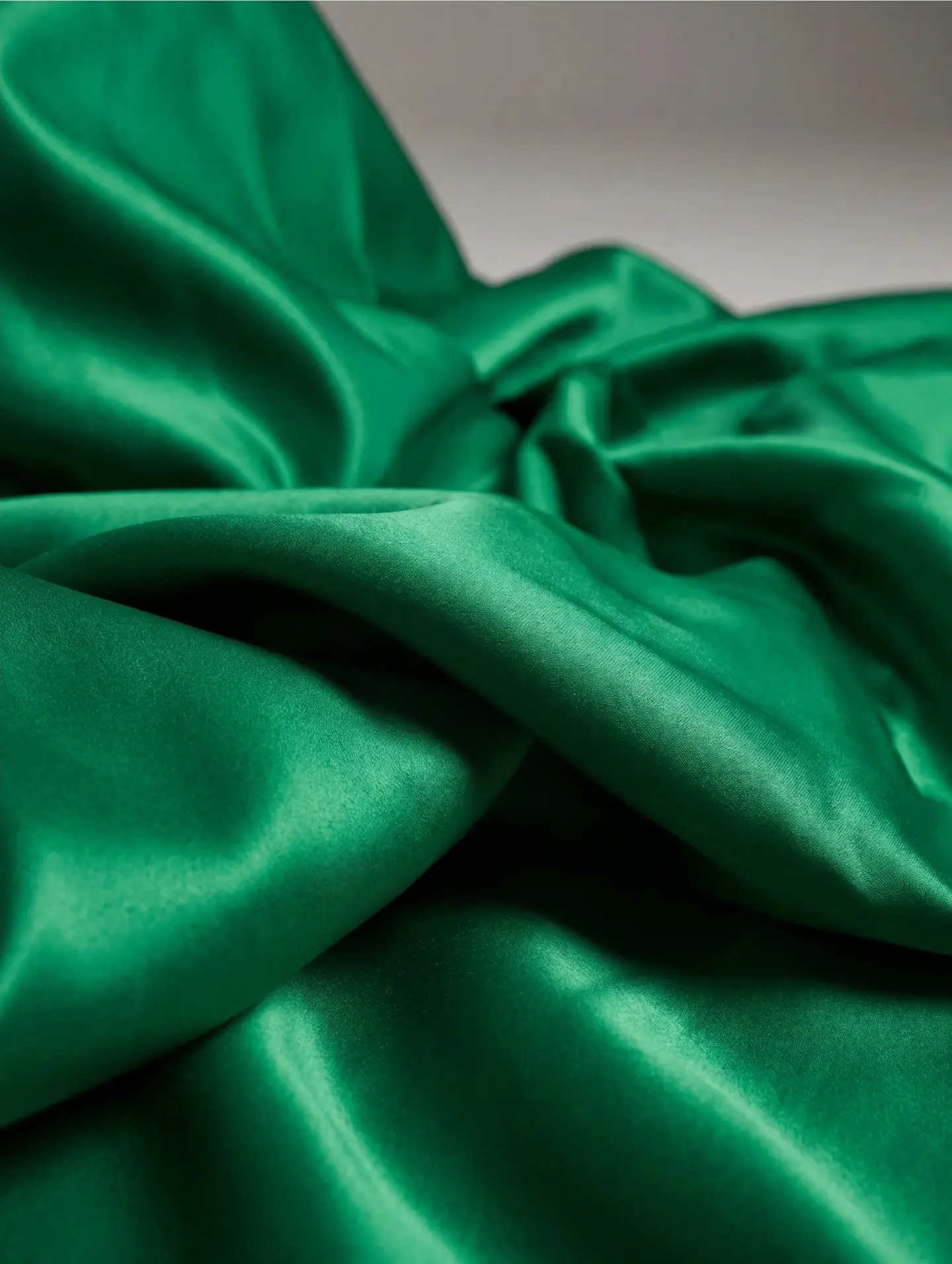 Close-up of draped emerald green silk fabric