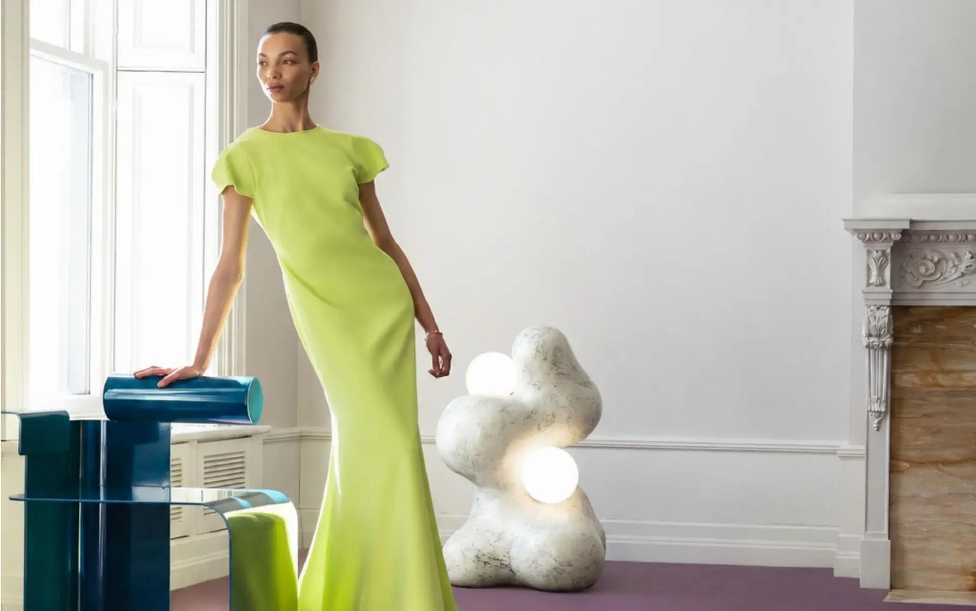 Model in lime green dress in elegant interior