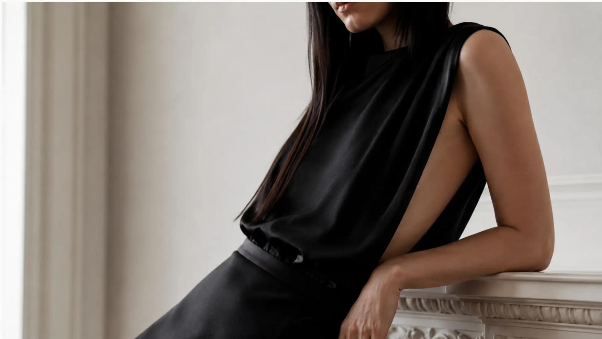 Close-up of model in black silk garment